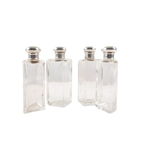 275 - A SPIRIT SET

late 19th century, the four spirit flasks with silver hallmarked tops, 14cm high, in t... 