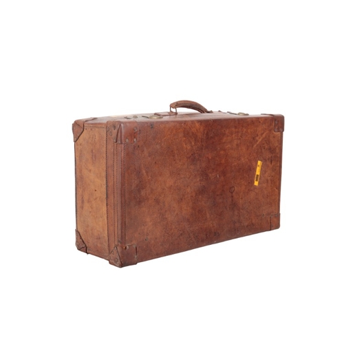 338 - AN EDWARDIAN BROWN LEATHER SUITCASE

with brass locks, leather carrying handles and brass studded co... 