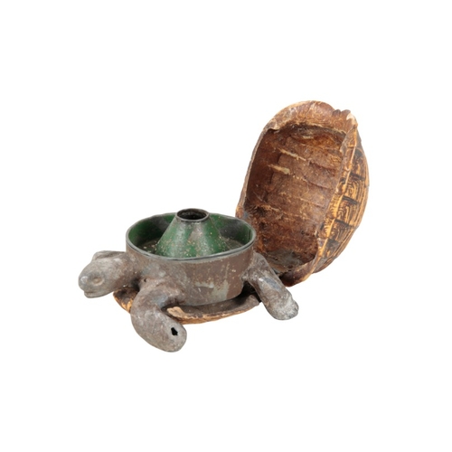 363 - A TORTOISESHELL INKWELL

circa 1900, the base metal inkwell and realistically modelled tortoise head... 