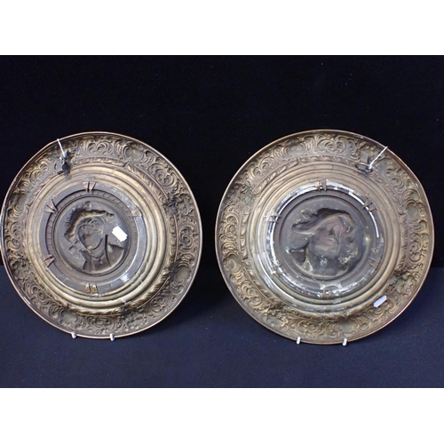 32 - A PAIR OF 19TH CENTURY RENAISSANCE REVIVAL PLAQUES the cast metal portrait centres in repousse brass... 