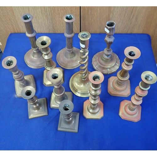 102 - A COLLECTION OF BRASS CANDLESTICKS four pairs and four singles, various styles