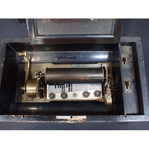 130 - A 19TH CENTURY CYLINDER MUSIC BOX with 15.5cm cylinder contained in grained case 15cm high, 38.5cm w... 