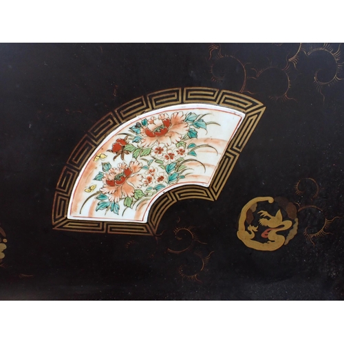 143 - A LARGE JAPANESE LACQUERED TRAY, EARLY 20th CENTURY mounted with three painted porcelain plaques 88 ... 