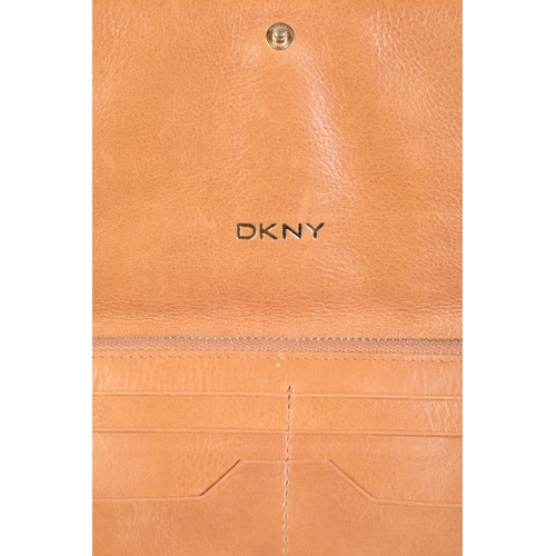 247 - DKNY: A BROWN LEATHER PURSE together with two DKNY handbags; two associated DKNY black fabric dust b... 