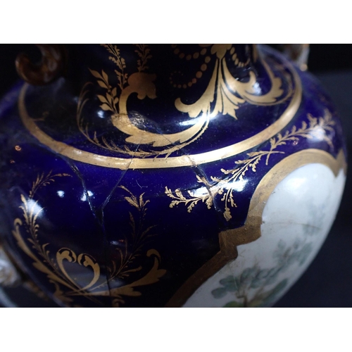 271 - A PAIR OF ROYAL CROWN DERBY BONE CHINA URNS AND COVERS enamelled with exotic birds within gilded blu... 