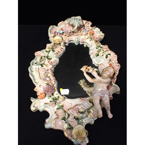 291 - A DRESDEN STYLE MIRROR WITH PUTTO and flowers (a/f)