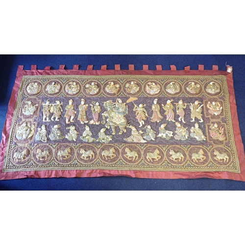 78 - A LARGE INDIAN EMBROIDERED WALL HANGING worked all over in relief with figures within panels, the ce... 