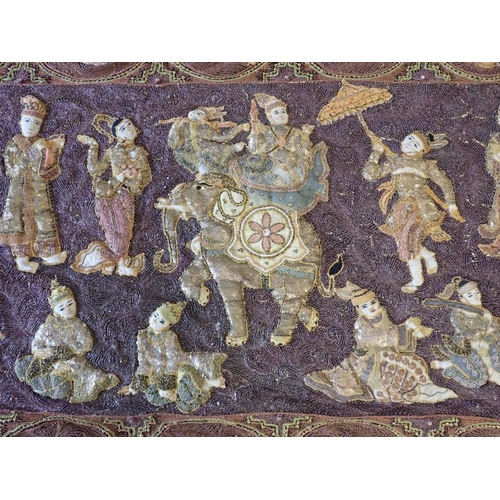 78 - A LARGE INDIAN EMBROIDERED WALL HANGING worked all over in relief with figures within panels, the ce... 