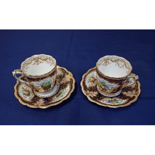 303 - A PAIR OF EARLY 19TH CENTURY ENGLISH PORCELAIN CABINET CUPS AND SAUCERS enamelled with fruit within ... 