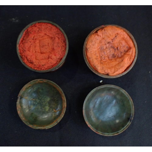 340 - A PAIR OF CHINESE CARVED STONE COVERED POTS with hardwood stands, with old labels and (ink?) content... 