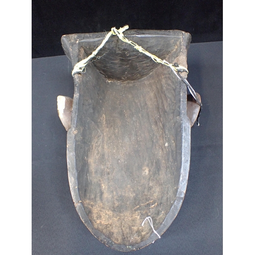 348 - A TRIBAL MASK; A BEARDED MAN with cowrie shell eyes 47cm high (woodworm damage)