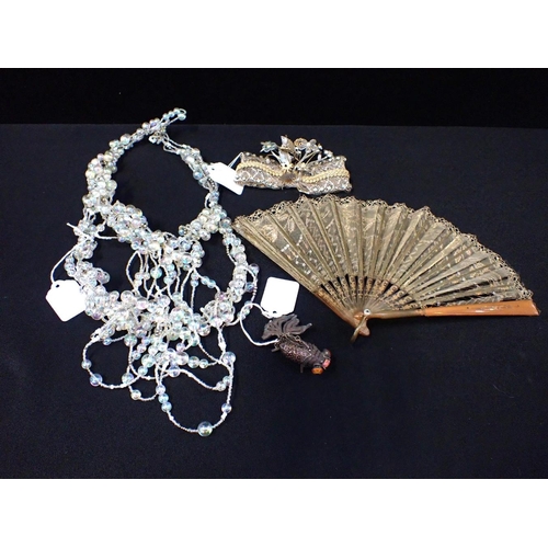 414 - AN ELABORATE IRIDESCENT BEAD NECKLACE a bow mounted with sequins and diamantes, and a sequinned fan ... 