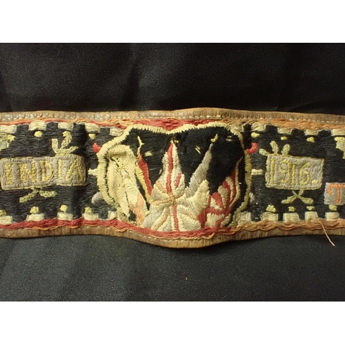 505 - A FIRST WORLD WAR EMBROIDERED BELT: 'INDIA' worked with motifs, flags of the Allies and date '1916' ... 