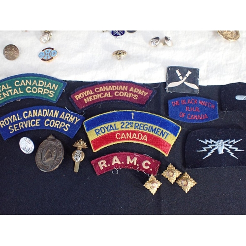 506 - A COLLECTION OF MILITARY BADGES including cloth badges, and other items