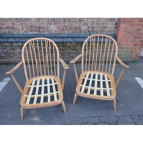 831 - A PAIR OF ERCOL 203 BEECH FRAMED WINDSOR ARMCHAIRS with low seats (labels missing) (note; these are ... 