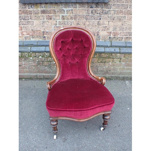 832 - A VICTORIAN WALNUT SPOONBACK NURSING CHAIR upholstered in maroon cloth, the back buttoned, on turned... 