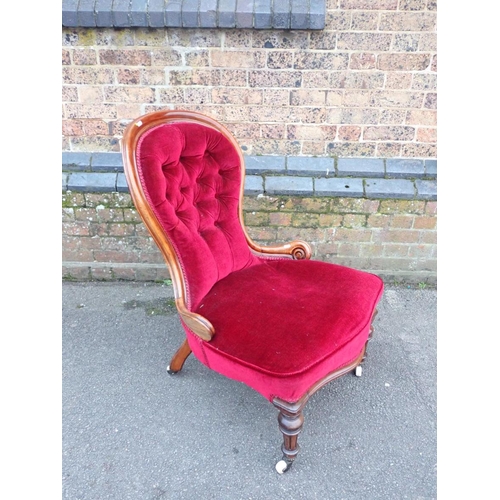 832 - A VICTORIAN WALNUT SPOONBACK NURSING CHAIR upholstered in maroon cloth, the back buttoned, on turned... 