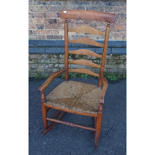 834 - A LANCASHIRE LADDERBACK ROCKING CHAIR ash, with rush seat (a/f), and arched crest rail, mid 19th cen... 