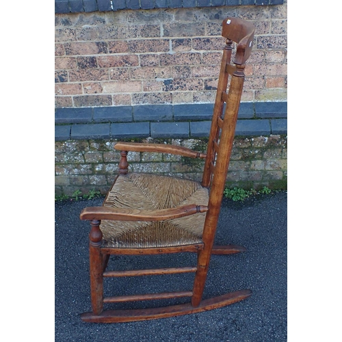 834 - A LANCASHIRE LADDERBACK ROCKING CHAIR ash, with rush seat (a/f), and arched crest rail, mid 19th cen... 