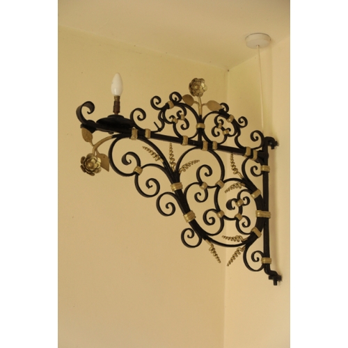 128 - A PAIR OF WROUGHT IRON LAMP BRACKETS

17th century or later, painted in black and gold, the scrollin... 