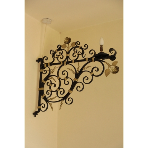 128 - A PAIR OF WROUGHT IRON LAMP BRACKETS

17th century or later, painted in black and gold, the scrollin... 