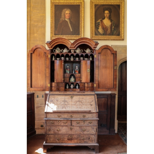 14 - A QUEEN ANNE DOUBLE-DOMED WALNUT BUREAU CABINET

inlaid with herringbone and crossbanding, the upper... 