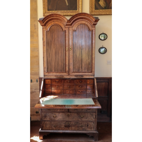 14 - A QUEEN ANNE DOUBLE-DOMED WALNUT BUREAU CABINET

inlaid with herringbone and crossbanding, the upper... 