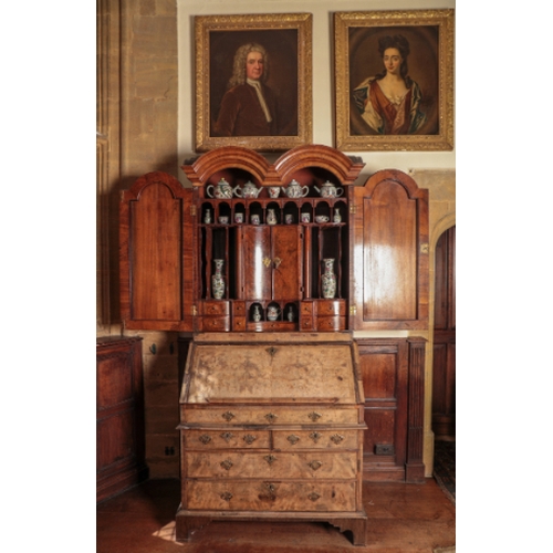 14 - A QUEEN ANNE DOUBLE-DOMED WALNUT BUREAU CABINET

inlaid with herringbone and crossbanding, the upper... 