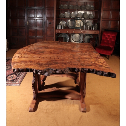 144 - A CONTEMPORARY BURR ELM DINING TABLE

by Tim Stead, designed as two trestle tables with thick burr e... 