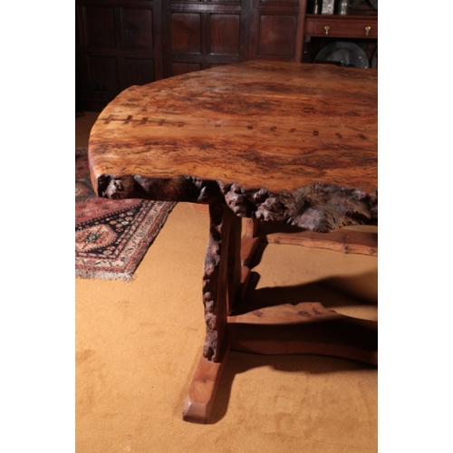 144 - A CONTEMPORARY BURR ELM DINING TABLE

by Tim Stead, designed as two trestle tables with thick burr e... 