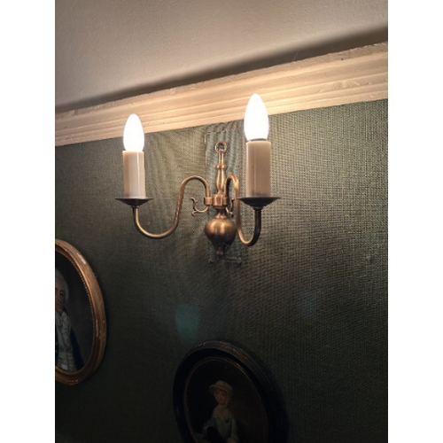 148 - A SET OF SIX GEORGE I STYLE BRASS WALL LIGHTS

each with two scrolling branches, fitted for electric... 