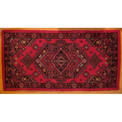 165 - A NORTH WEST PERSIAN HERIZ STYLE RUG

20th century, with central floral medallion on a brick red gro... 