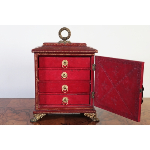 175 - A REGENCY RED MOROCCO JEWELLERY CASKET

with gilt tooled decoration, the gadrooned top with a gilt m... 