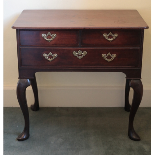 194 - A GEORGE II MAHOGANY LOW BOY

the rectangular top with rounded corners and a moulded edge over two s... 