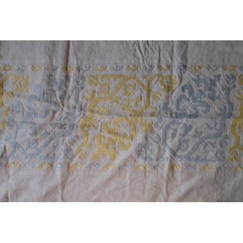 303 - A RAISED WORK BEDSPREAD

with three panels of stylised flowers and branches, worked in yellow and bl... 