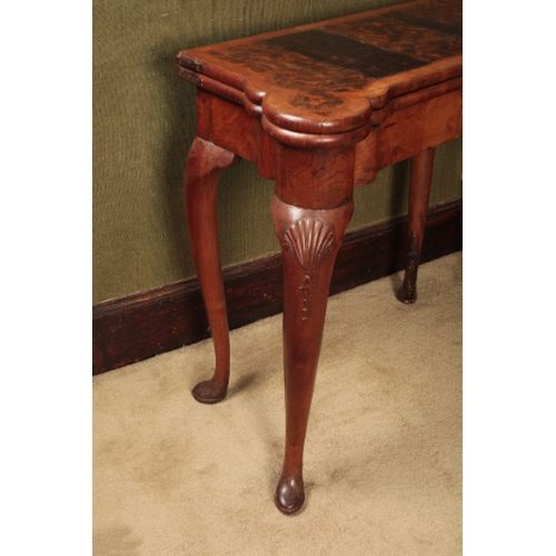 310 - A GEORGE I WALNUT TEA TABLE

the folding rectangular top with projecting ears for candles and with s... 