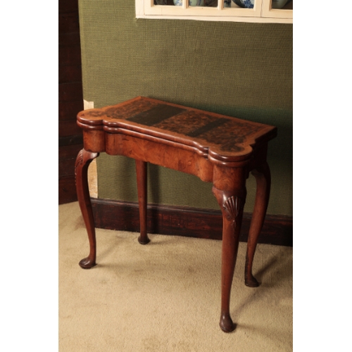 310 - A GEORGE I WALNUT TEA TABLE

the folding rectangular top with projecting ears for candles and with s... 