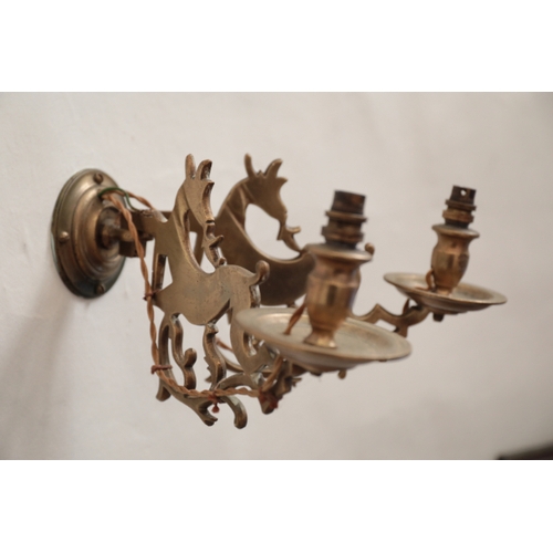 333 - A BRASS WALL LIGHT

with two arms designed as running deer, fitted for electricity; and two other wa... 