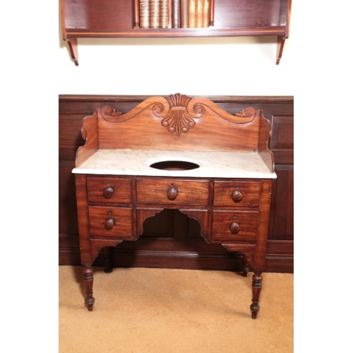 351 - A WILLIAM IV MAHOGANY WASH STAND

with a raised gallery carved with a stylised anthemion between 