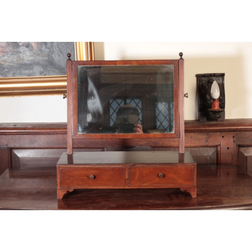 353 - A LATE GEORGE III MAHOGANY DRESSING MIRROR

of Sheraton design, with a rectangular plate and a box b... 