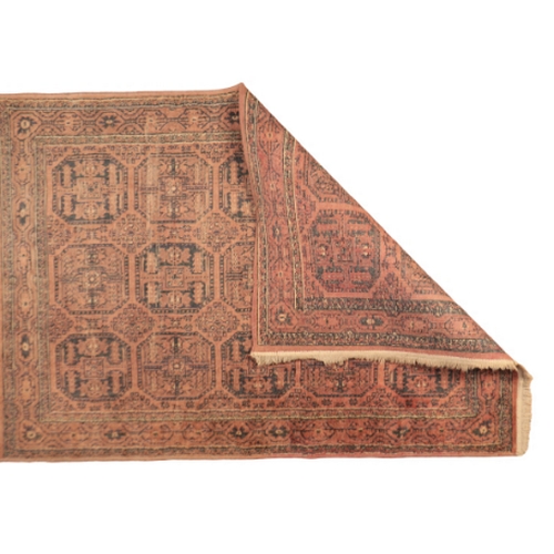 373 - A BOKHARA STYLE MAT

in shades of brown, orange and cream, with a central field containing conjoined... 