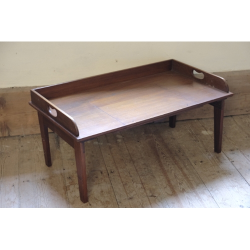 404 - A MAHOGANY BUTLER'S TRAY

early 20th century, with folding legs, 58cm high x 68cm wide x 43cm deep; ... 