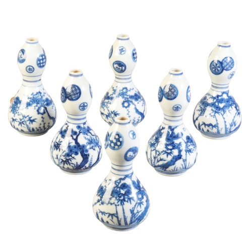 42 - A SET OF JAPANESE BLUE AND WHITE GOURD-SHAPED BOTTLE VASES

Edo, decorated with foliage and trees, t... 