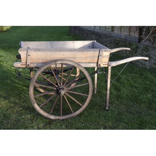 461 - AN OAK CART/MARKET BARROW

the black painted undercarriage with iron wheel rims, 206cm long (includi... 