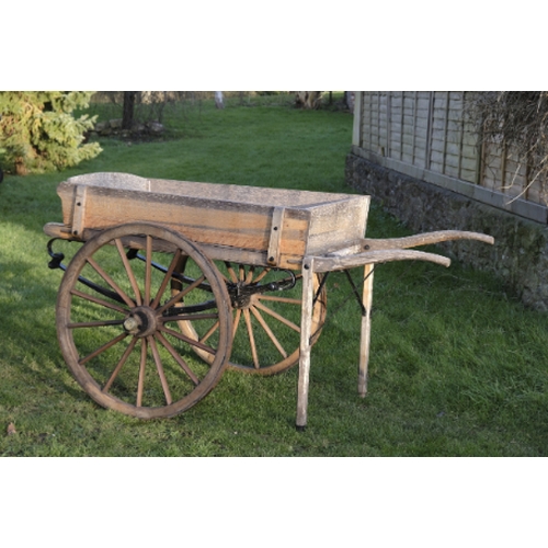 461 - AN OAK CART/MARKET BARROW

the black painted undercarriage with iron wheel rims, 206cm long (includi... 