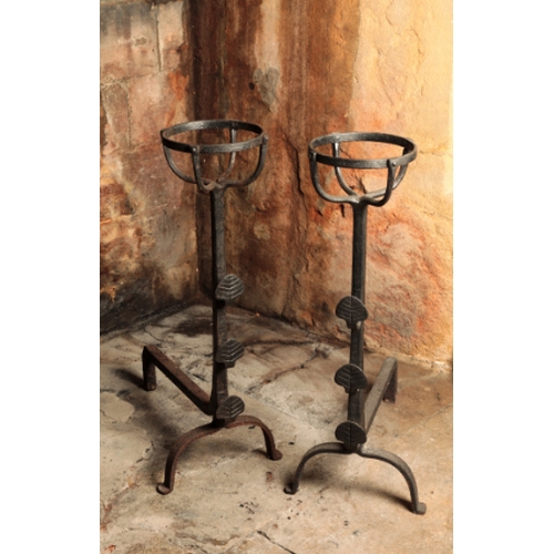 57 - A PAIR OF WROUGHT IRON ANDIRONS

17th century or later, with basket tops supported on tapering colum... 