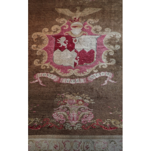 59 - AN IMPORTANT AXMINSTER HERALDIC CARPET

with a central armorial of the Medlycott family surmounted b... 