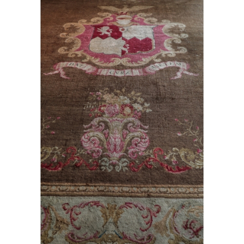 59 - AN IMPORTANT AXMINSTER HERALDIC CARPET

with a central armorial of the Medlycott family surmounted b... 