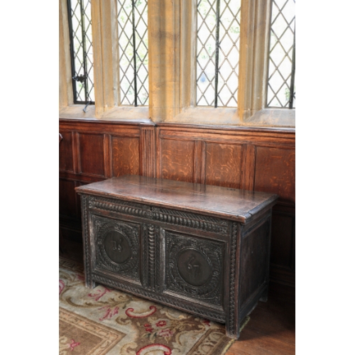 6 - A CHARLES II OAK COFFER

the plain hinged top over a frieze carved with scalework and two panels car... 