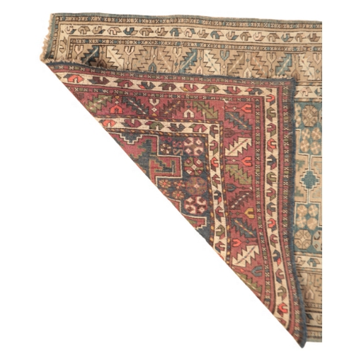 61 - A BOKHARA RUG

with a brick red field containing three rows of guhls within multiple foliate borders... 